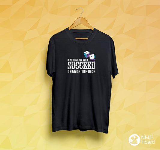 Unisex black T-shirt with bold text 'If at first you don't Succeed, Change the dice', displayed on vibrant yellow backdrop.