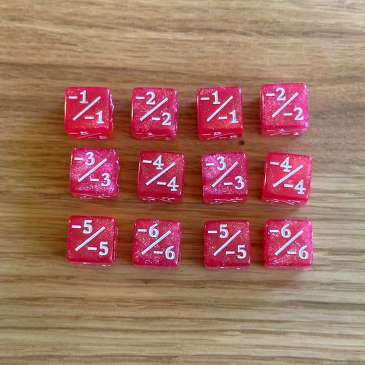 Set of twelve 12mm D6 -/- minus minus dice in glitter pink with white infill. each dice is numbered 1-6 on each side to track incremental negative modifiers.