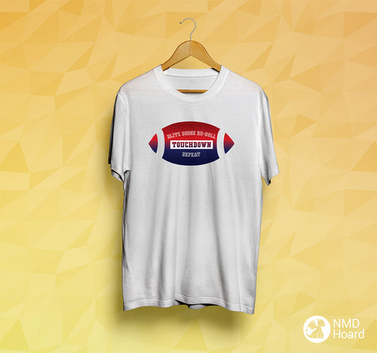 White t-shirt with football graphic and text 'Blitz Dodge Re-Roll Touchdown Repeat' on a yellow geometric pattern background