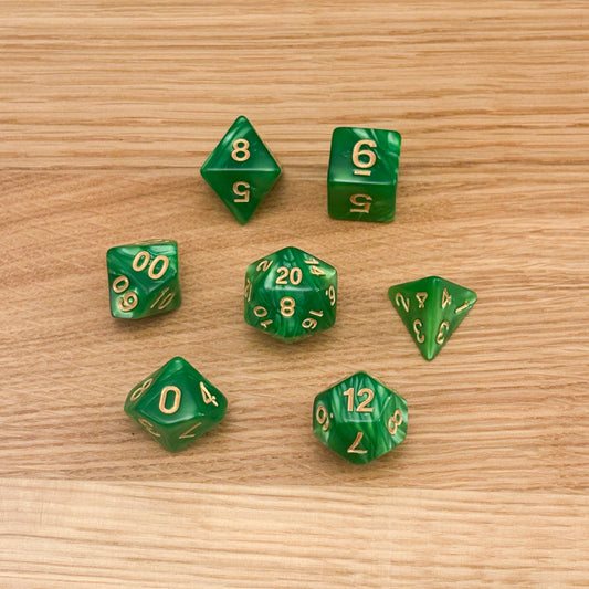 Set of 7 polyhedral dice (D4, D6, D8, D10, percentile D10, D12, D20) in swirled green acrylic with gold number infill.