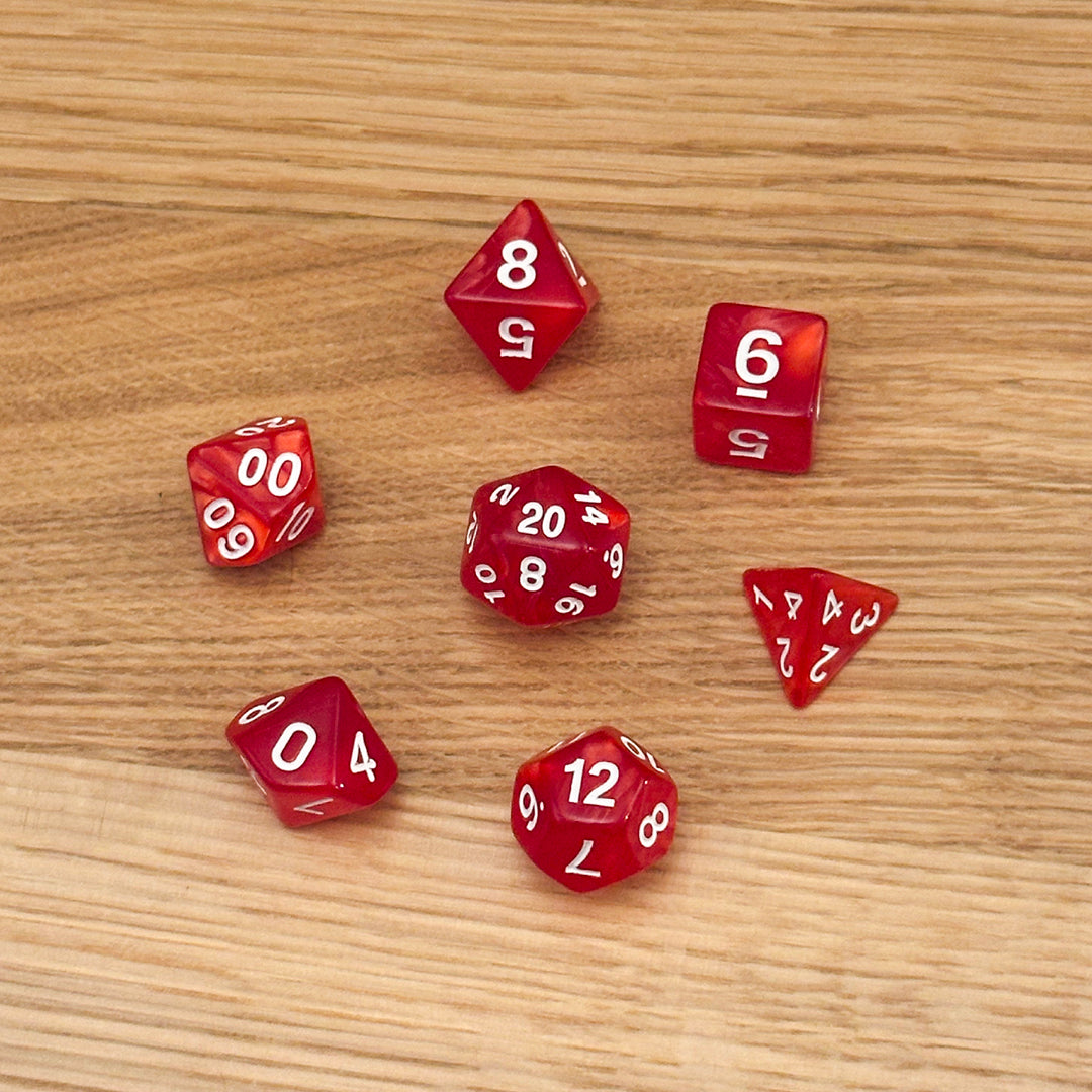 Set of 7 polyhedral dice (D4, D6, D8, D10, percentile D10, D12, D20) in swirled red acrylic with white number infill.