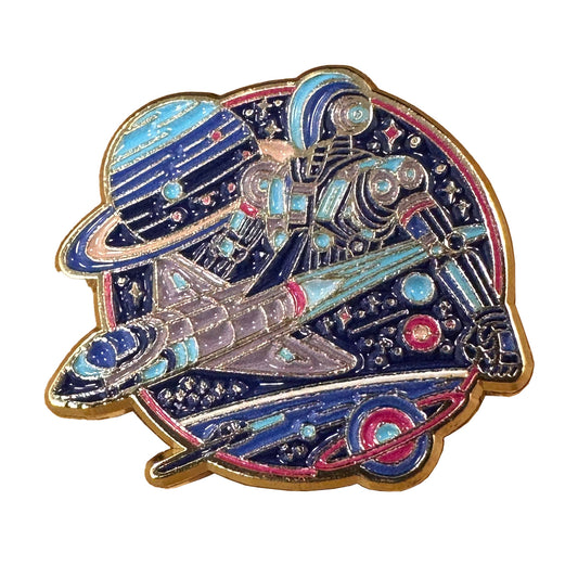 One-inch gold-tone soft enamel pin featuring a robot in space with blue enamel details, planets, and spaceships.