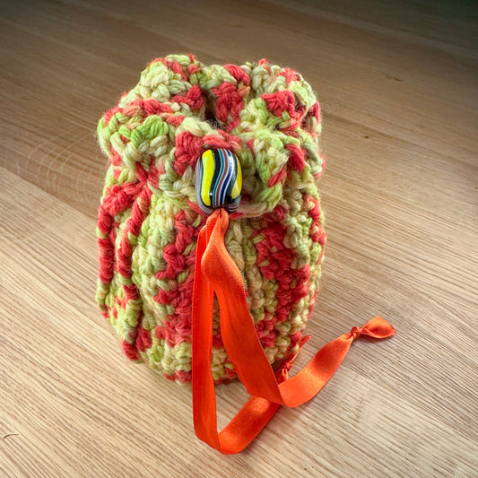 closed yellow, lime and orange crochet bag with black and yellow glass bead closure. Part of the handmade hoard and fateweaver's collection.